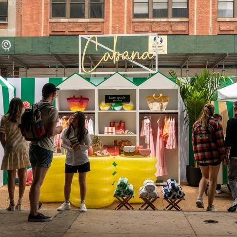 Visitors participate in the Kate Spade Cabana brand activation in the Meatpacking District of New York on Friday, May 20, 2022 . Kate Spade, a brand of Tapestry, introduces Kate Spade Cabana, a seasonal summer line of merchandise, with pop-up ?cabanas? ar